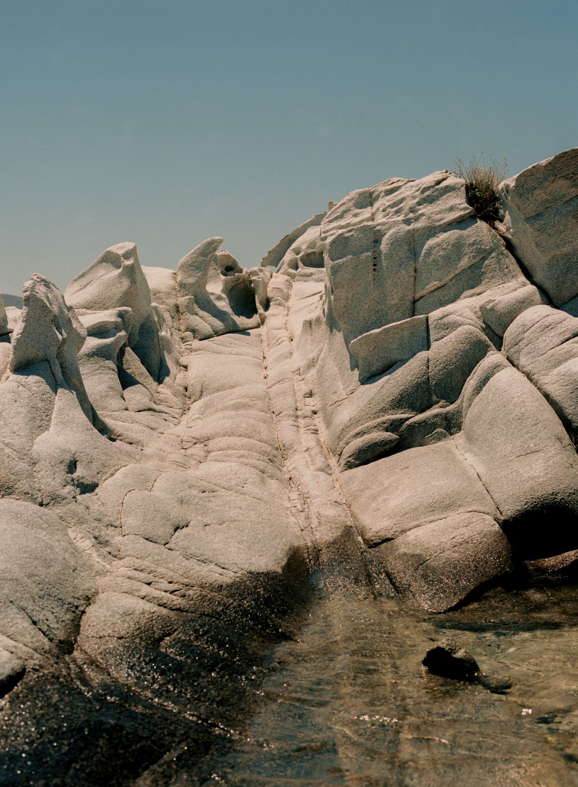 White rocky coastline under a clear blue sky
